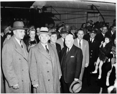 Vice President-elect Alben W. Barkley standing with several unidentified people. Barkley had just returned to... - NARA - 199941