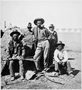 Warm Spring scouts, Lava Beds, California, their leader, Donald McKay, is leaning against rock, 1873 - NARA - 533246 photo