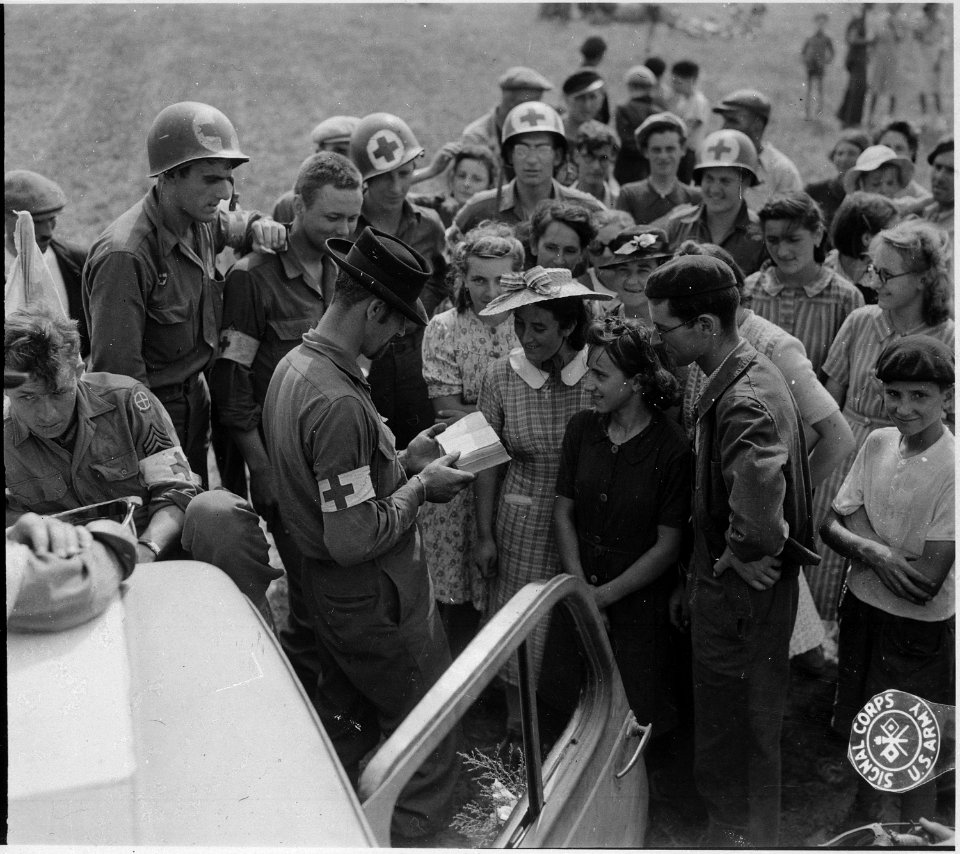 Wearing a civilian hat salvaged along the way, a bearded GI amuses both GI's and French civilians as he tries to make... - NARA - 531502
