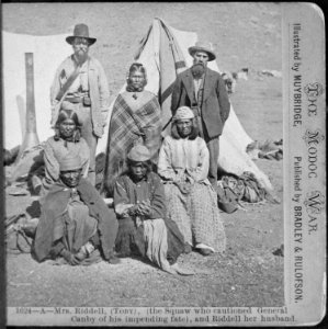 Winema or Tobey Riddle, a Modoc, standing between an agent and her husband Frank (on her left), with four Modoc women in - NARA - 533247 photo
