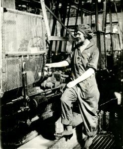 Woman turning shell in lathe photo