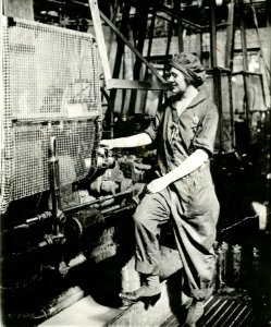 Woman turning shell in lathe