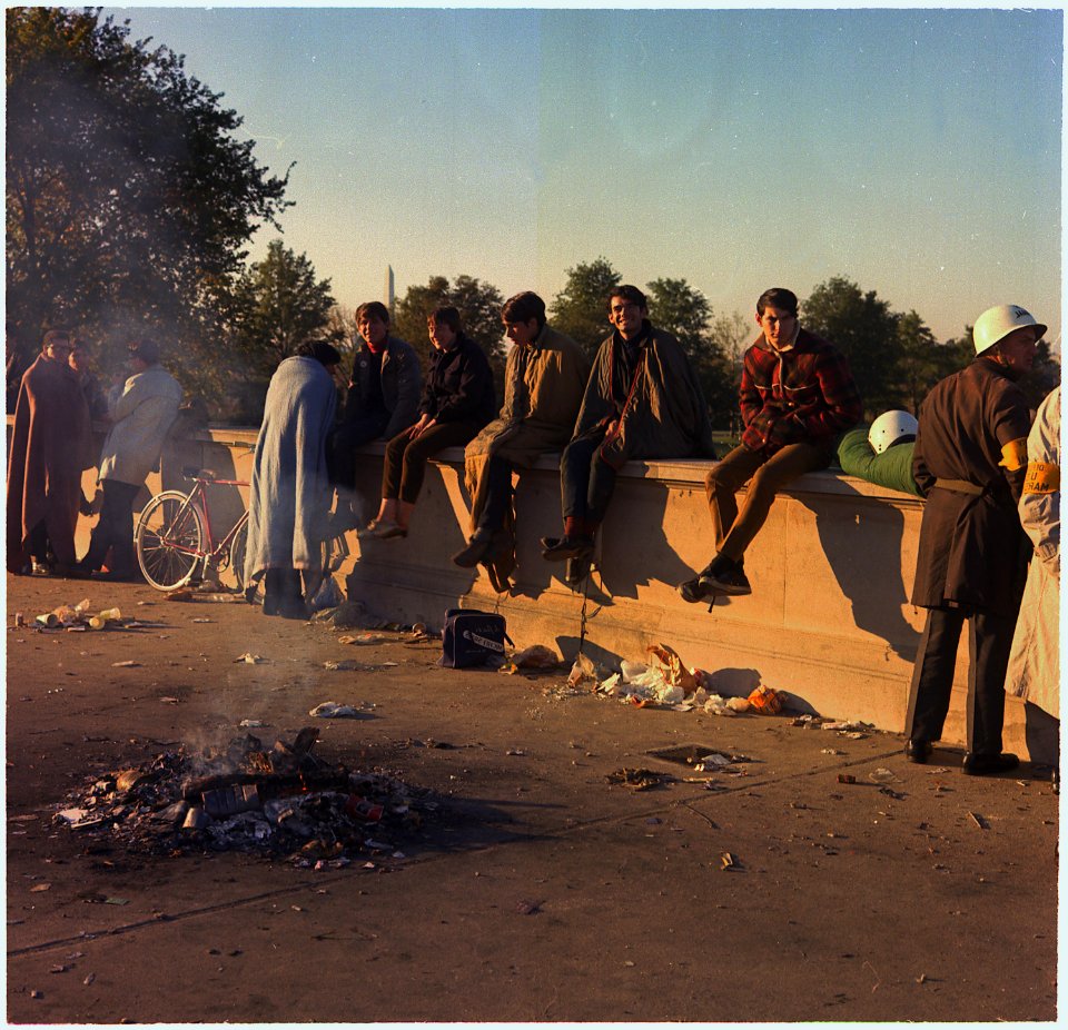 Washington, D.C. Anti-Vietnam Demonstration. Protesters sit on the wall around their bonfire after spending the night... - NARA - 530619