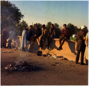 Washington, D.C. Anti-Vietnam Demonstration. Protesters sit on the wall around their bonfire after spending the night... - NARA - 530619 photo