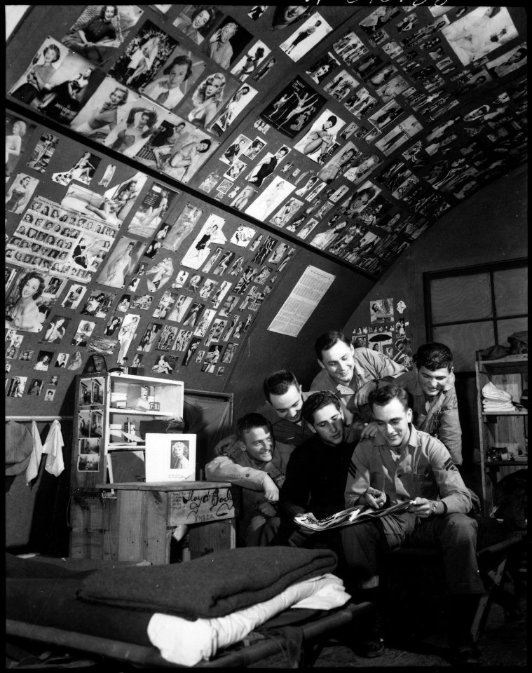 With nearly 3,000 pin-ups (including over 200 shots of Marilyn Monroe) serving as wallpaper for their quonset hut... - NARA - 532470