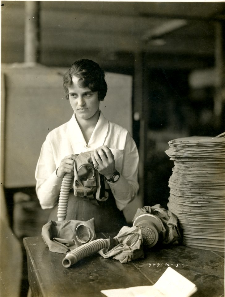 Woman assembling gas masks