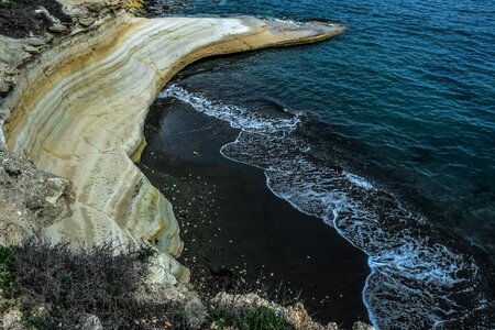Seashore rock black sand photo