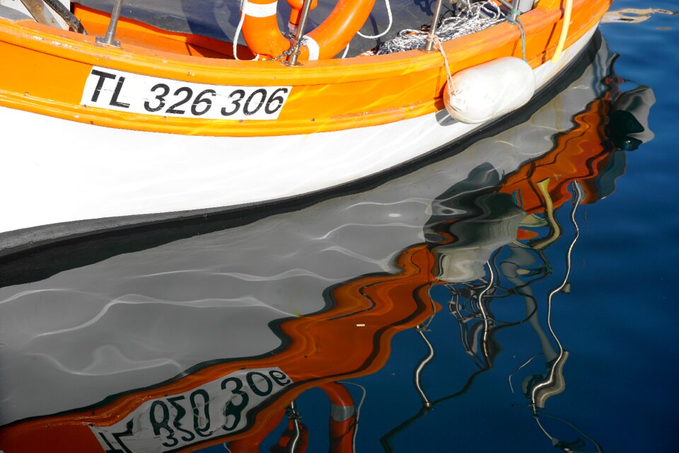 Mirroring by the sea fishing boat
