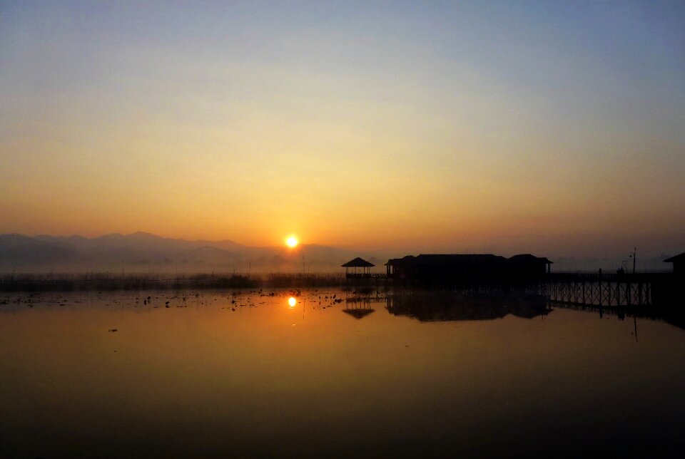 Body of water sun twilight
