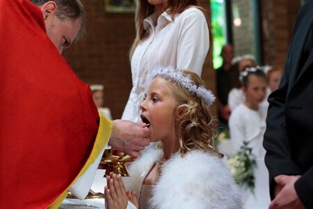 The ceremony first communion to give the sacrament photo