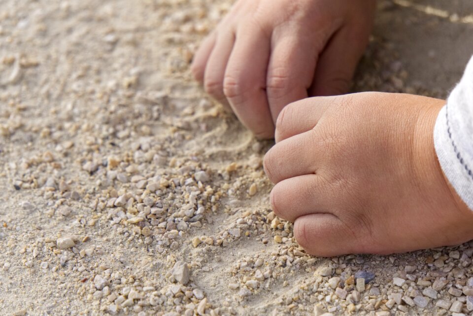 Sand pebble child's hand