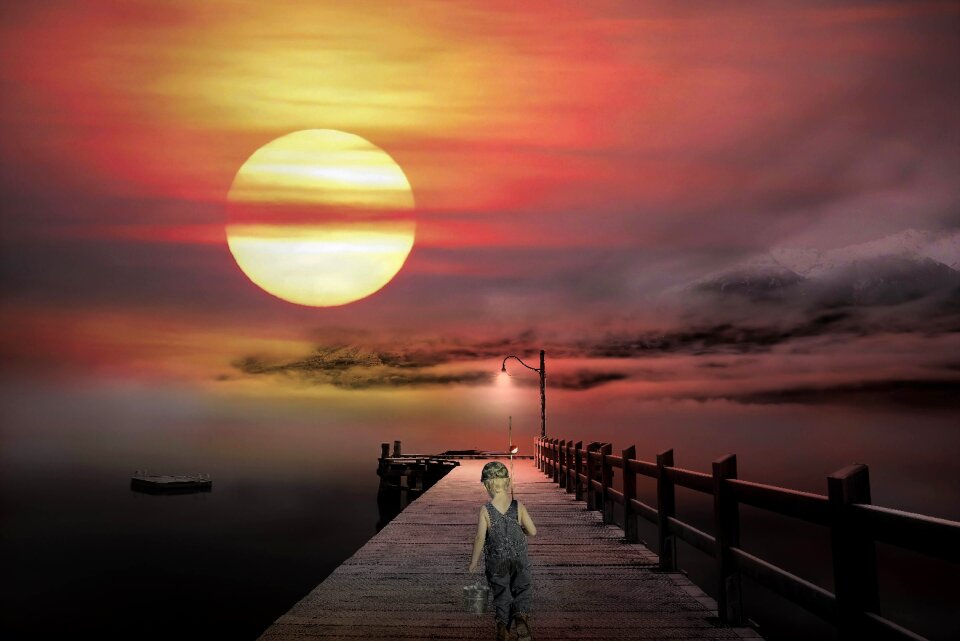 Boy fish evening sky
