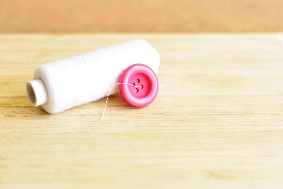 Pink button white yarn thread