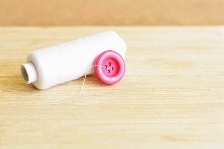 Pink button white yarn thread