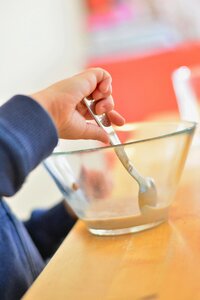 Child's hand spoon bowl photo