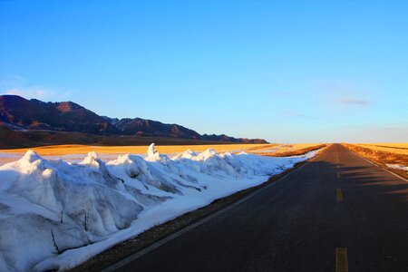 Snow mountain highway blue sky photo