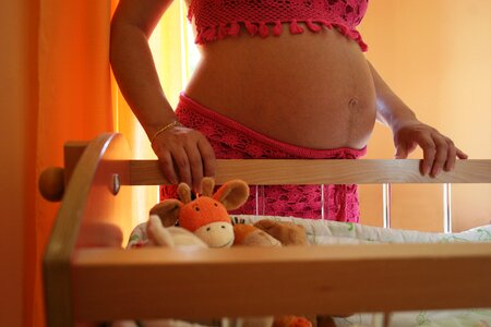 Pregnant woman wait for a child cradle