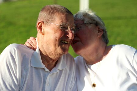 Outdoors snuggling senior citizens