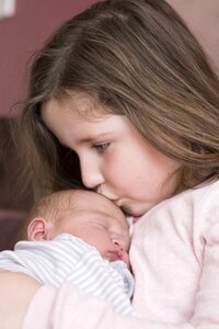 Newborn kiss girl photo