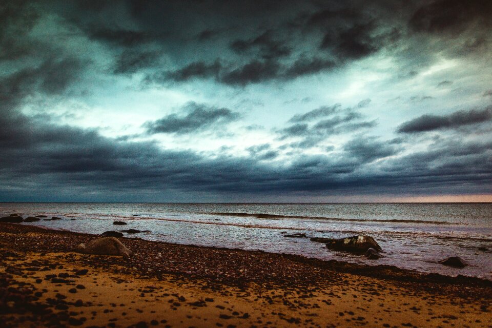 Rocks clouds dark sky