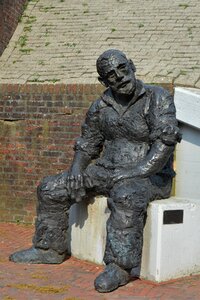 Old man on a stone sculpture old man