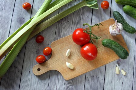 Tomatoes garlic cutting board photo