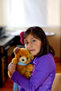 Girl with teddy bear portrait foreground photo