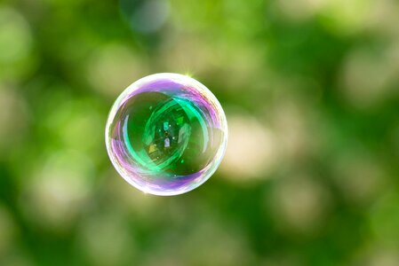 Children make soap bubbles play outside photo