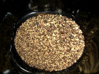 A dish of roughly mashed Black Peppercorns photo
