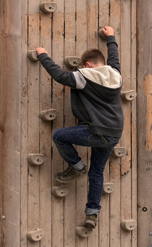 Climber climbing holds boulder wall