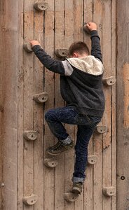 Climber climbing holds boulder wall