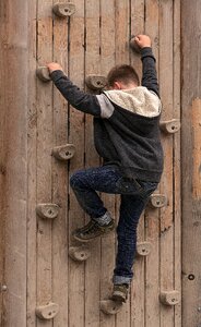 Climber climbing holds boulder wall photo