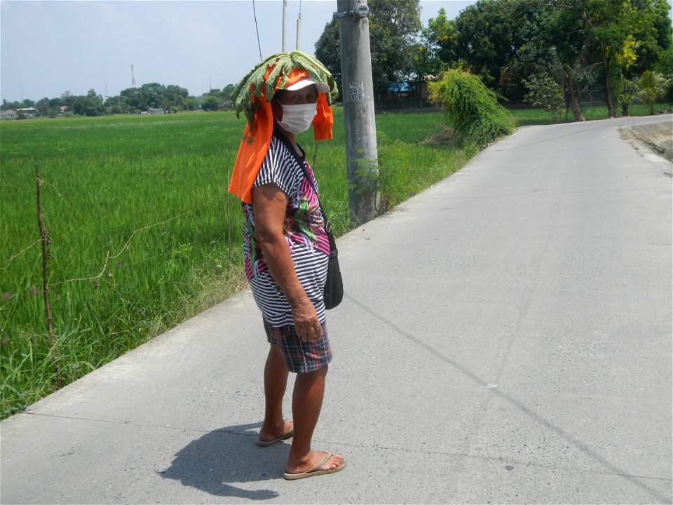 Smoking women with carica papaya leaves hat