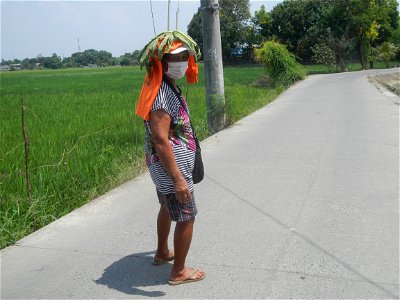 Smoking women with carica papaya leaves hat photo