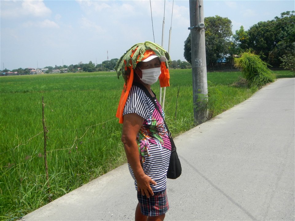 Smoking women with carica papaya leaves hat
