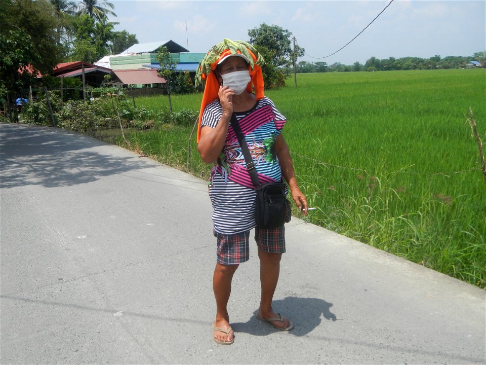 Smoking women with carica papaya leaves hat