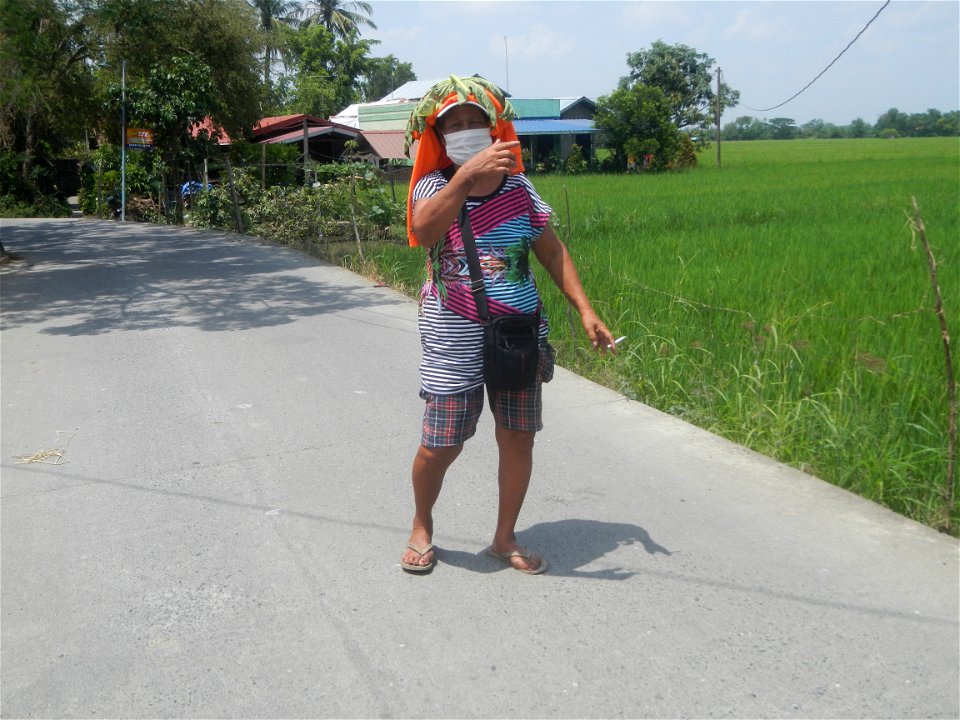 Smoking women with carica papaya leaves hat