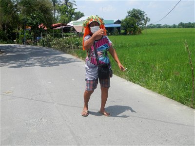Smoking women with carica papaya leaves hat