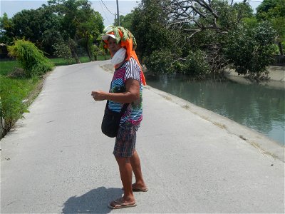 Smoking women with carica papaya leaves hat