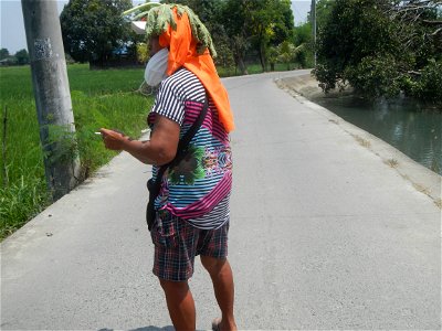 Smoking women with carica papaya leaves hat