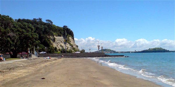 Looking west from the Mission Bat beach onto one of the cliff sections overhanging Tamaki Drive] in Auckland, New Zealand. photo
