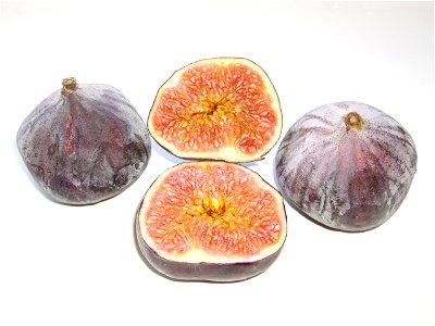Two whole common figs and one fruit cut open photo