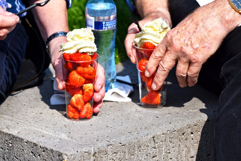 Woman's hand cup strawberry