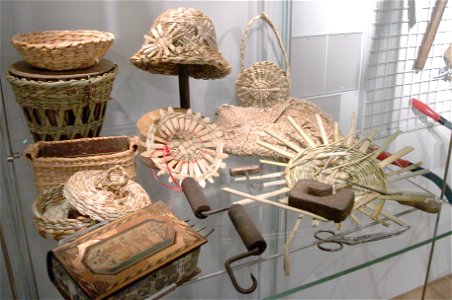 A display of objects made of rushes of various ages, from the nineteenth century to the present and some rush-working tools. Some of the more recent work was done by Pamela Morgan her students. The photo