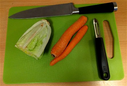 A pedagogical image related to the "Procedure (detailed)" "Method" steps in Wikibooks Cookbook:Salmon with Rice and Sauce (Q86594655) Step 13: Carrots and Romaine lettuce, with peeler and a kitchen kn photo
