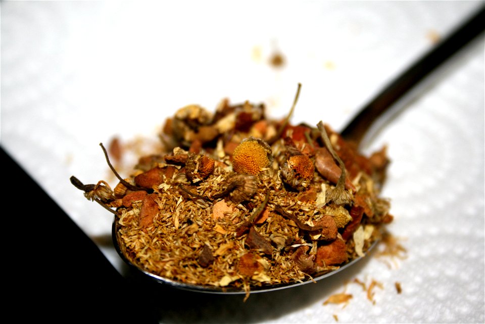 Loose chamomile tea with dried bits of apple and cinnamon photo