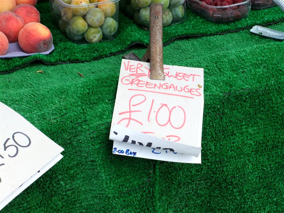 Market stall sign advertizing greengages, England, 2010