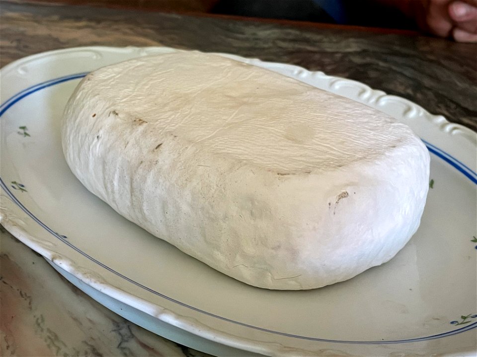 A Brick sized Camembert on a plate