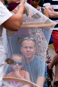 Emma, 6, and Alan Ashby listen to volunteers with Monarch Teacher Network, give remarks to nearly 30 attendees of a butterfly release in Arlington National Cemetery, Aug. 9, 2016, in Arlington, Va. Th