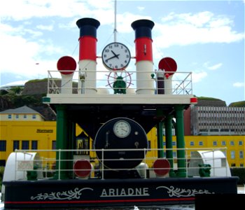 A photograph of the Jersey waterfront steam clock in Saint Helier. The Jersey steam clock is a full-scale replica of the centre section of a paddle steamboat named the Ariadne.  Although once powered 